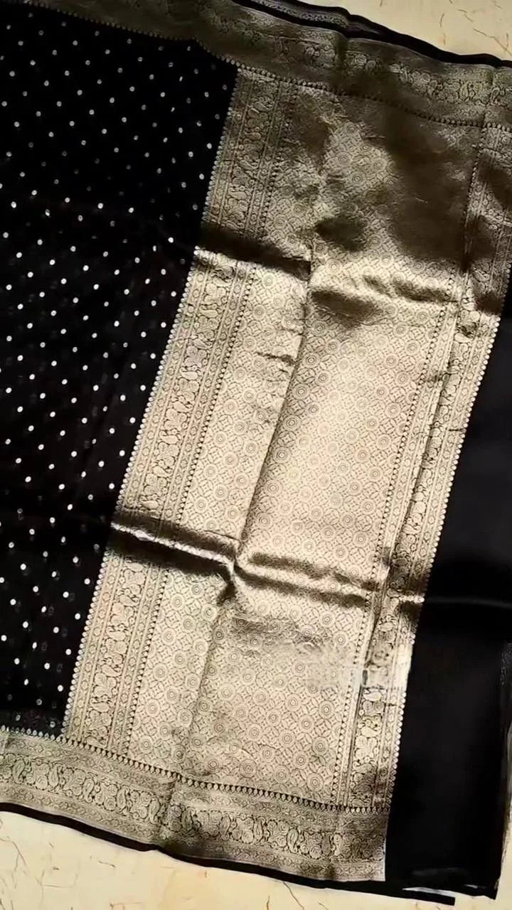 Black fabric with intricate white patterns on a textured surface