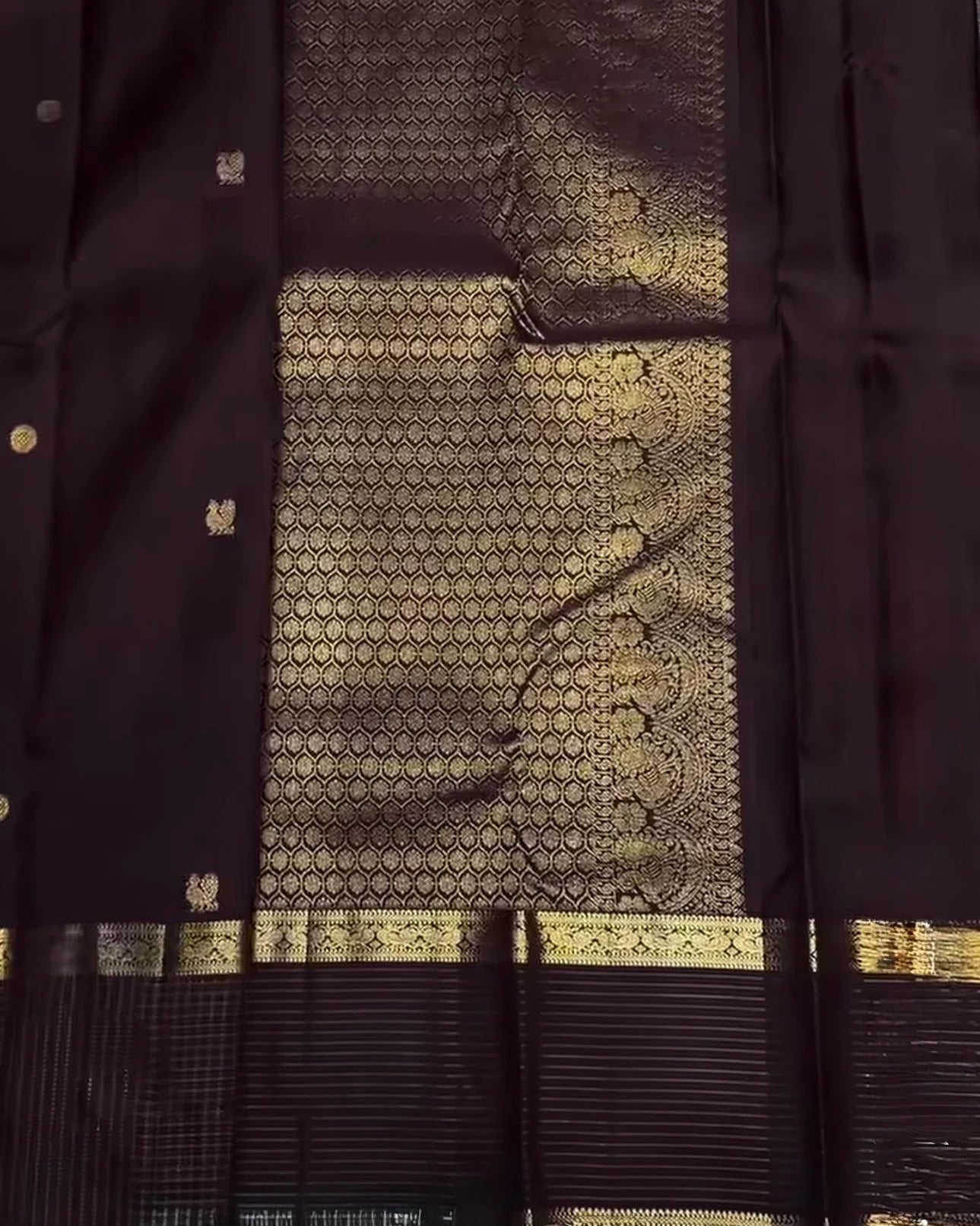 Dark fabric with gold patterns and trim
