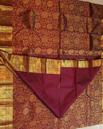 Decorative fabric with intricate patterns and a prominent purple triangle on a beige background