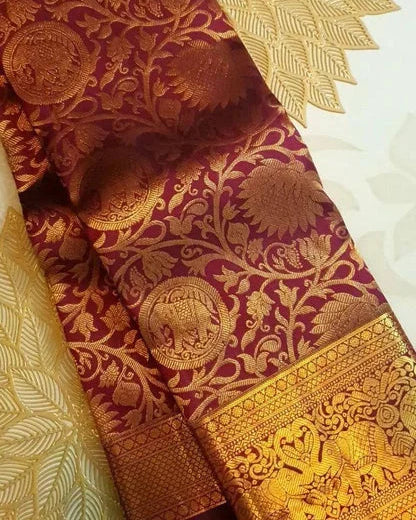 Close-up of a maroon fabric with gold intricate patterns and border