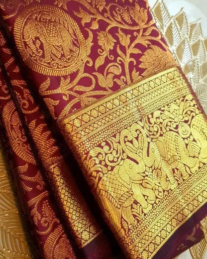 Maroon and gold traditional fabric with intricate patterns