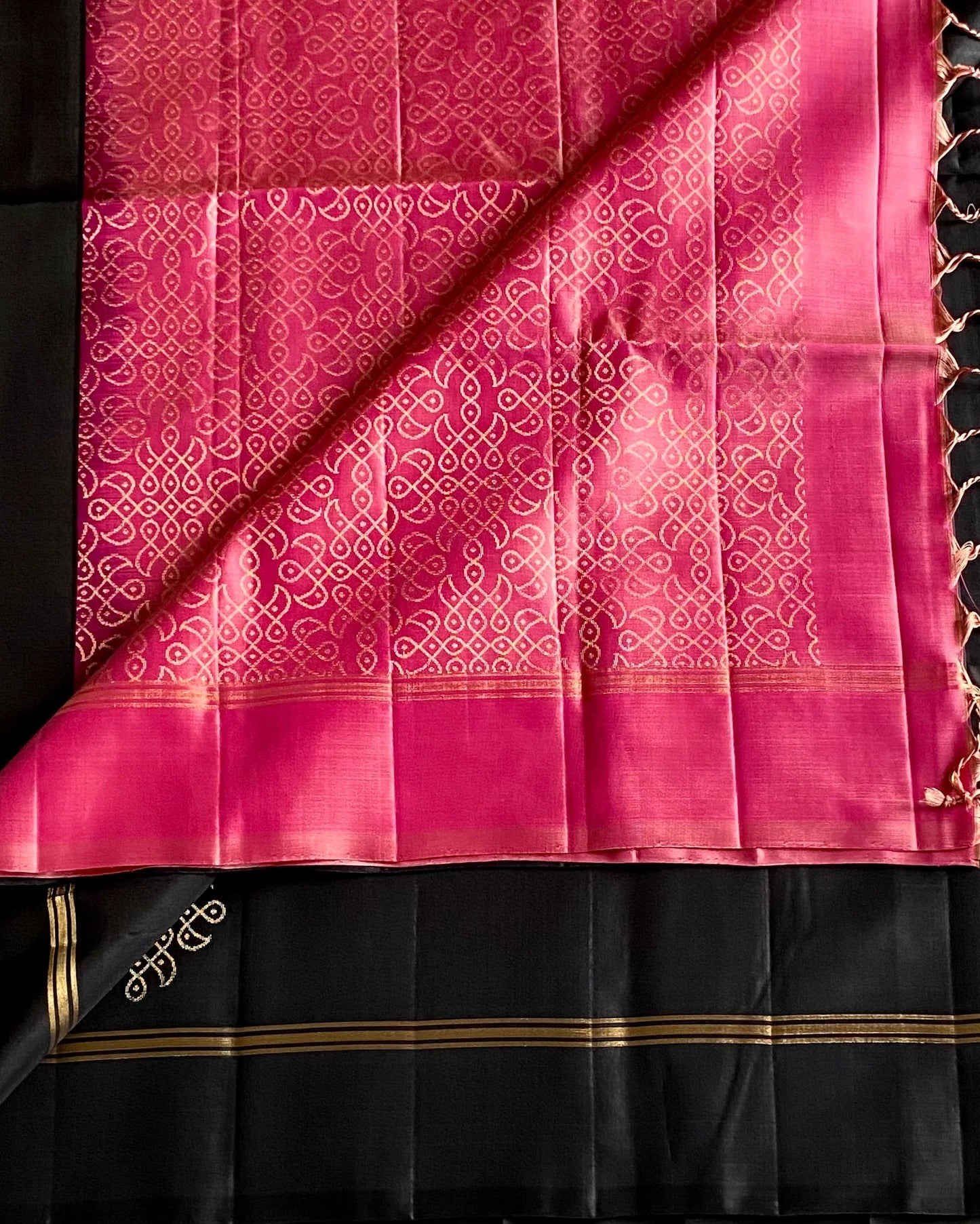 Black and pink saree with intricate patterns