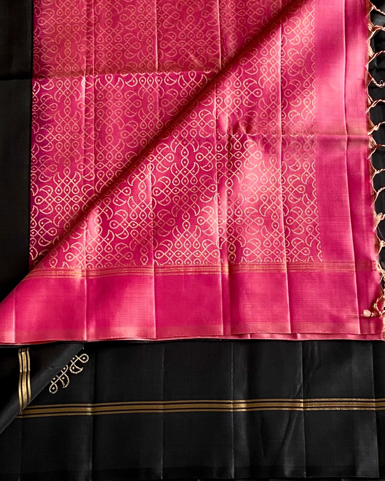 Black and pink saree with intricate patterns