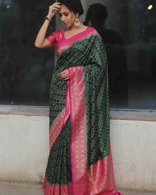 Woman wearing a green and pink saree with a blurred background
