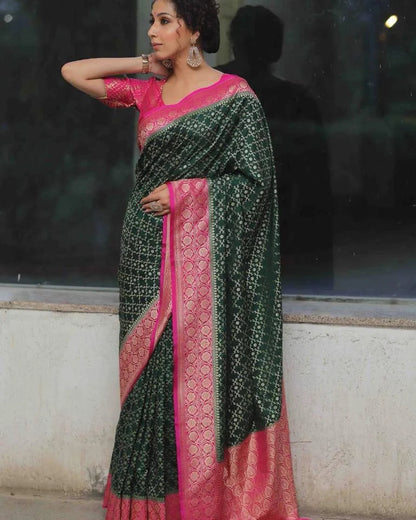 Woman wearing a green and pink saree with a reflective surface in the background