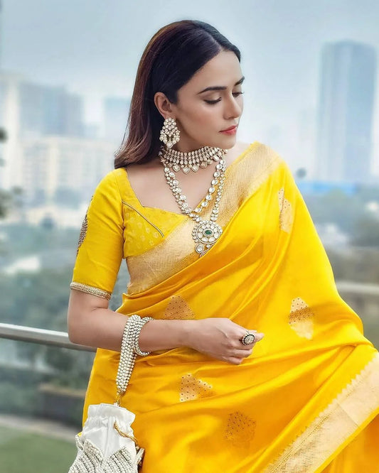 Woman in a yellow saree with cityscape in the background
