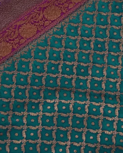 Close-up of a fabric with a green diamond pattern and purple border